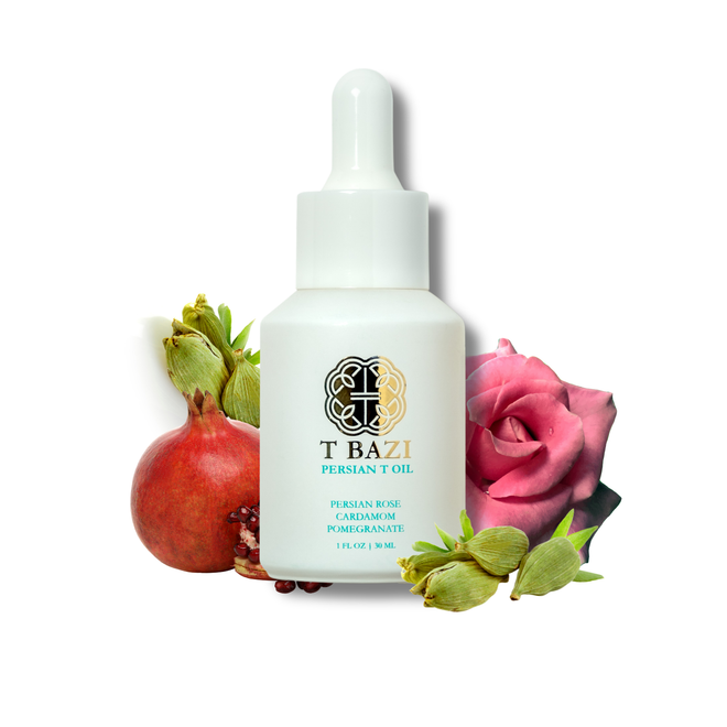 A white dropper bottle of TBAZI Persian Rose Cardamom Pomegranate oil, styled with a fresh pomegranate, rose petals, and green buds on a solid white background.