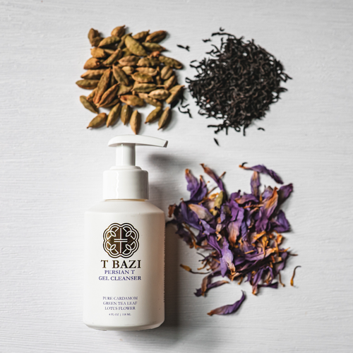 T Bazi Persian Gel Cleanser bottle on a white textured background, styled with loose green tea leaves, cardamom seeds, and dried purple flowers.
